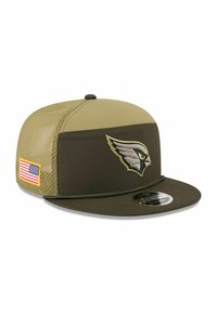 Olive green cap with a flat brim, featuring a raised embroidered bird logo and an American flag patch on the side. Textured mesh panel.