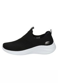 Svart atletisk slip-on sko med en teksturert strikkoverdel, polstret hvit mellomsåle og liten logo på hælen.