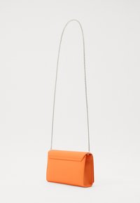 Orange mini handbag with a rectangular shape, smooth texture, and a silver chain strap. Features a flap closure and minimalistic design.