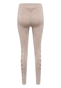 Jasnobrązowe legginsy wykonane z teksturowanej tkaniny, z trójkątnym akcentem z tyłu i zygzakowatym wzorem po bokach.