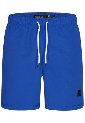 Blå svømmedragt med elastisk talje, hvid snor og et lille sort logo-patch. Glat stof og længde til midt på låret.