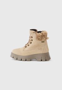 Botte chelsea en suède beige avec col en fausse fourrure, design à lacets, semelle extérieure en caoutchouc robuste et logo discret sur le côté.