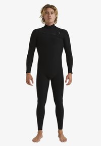 Black wetsuit with long sleeves and full legs. Smooth texture, front zipper, knee pads, and fitted design for water sports.