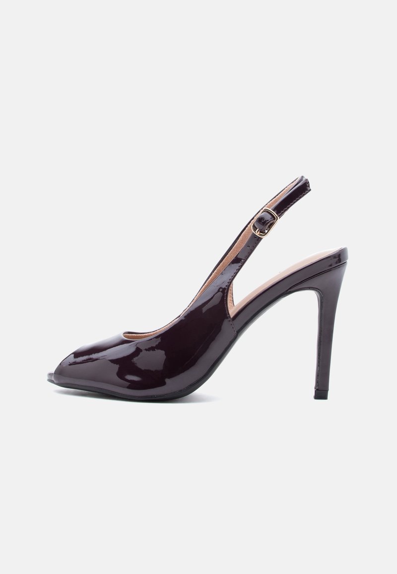 Σκούρο μοβ λουστρίνι πέδιλο με ψηλό τακούνι, μυτερή μύτη και ρυθμιζόμενο λουράκι με πόρπη.