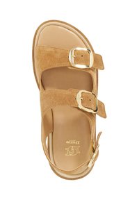 Tan suede sandal with two adjustable straps featuring gold buckles. Smooth inner sole and flat rubber outsole. Simple, open design.