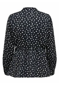 Blusa nera con pois bianchi, maniche lunghe e vita cinchata. Presenta un colletto e un design peplum nella parte inferiore.