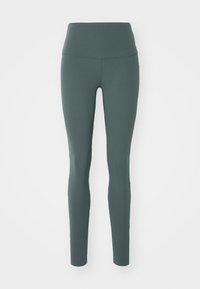 Legginsy z wysokim stanem w głębokim odcieniu niebieskiego, wykonane z elastycznej tkaniny, charakteryzujące się gładką fakturą i dopasowanym krojem. Bez widocznych wzorów.