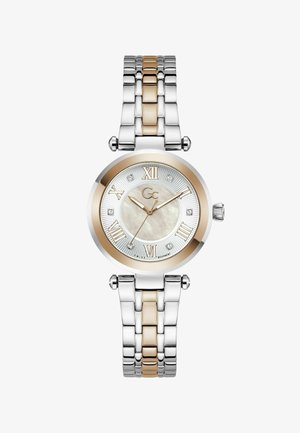 Ümmargune hõbedane ja roosast kullast käekell Rooma numbrite, teemanttundide markerite, kolme osutiga ning metallist linkidest valmistatud käerihmaga.