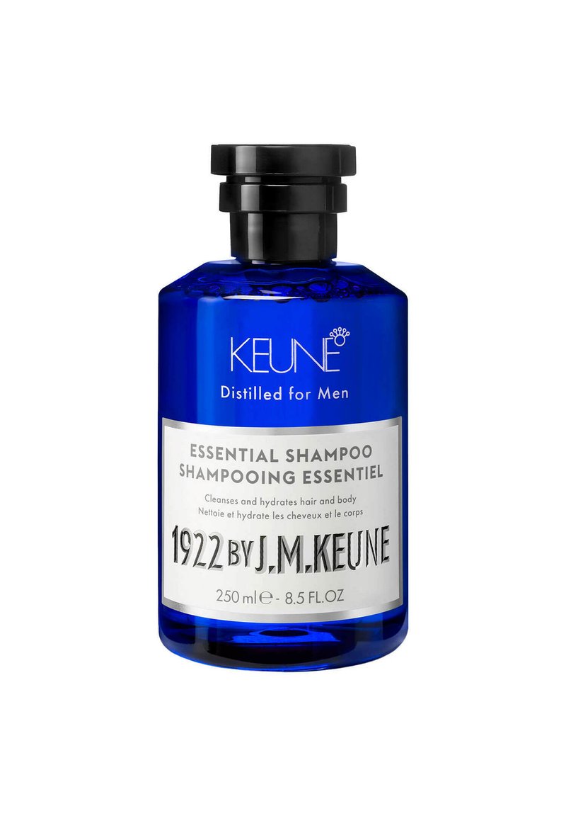 Bottiglia di vetro blu con un tappo nero. L'etichetta presenta un testo bianco che descrive il prodotto. Contiene 250 ml di shampoo essenziale per uomo.