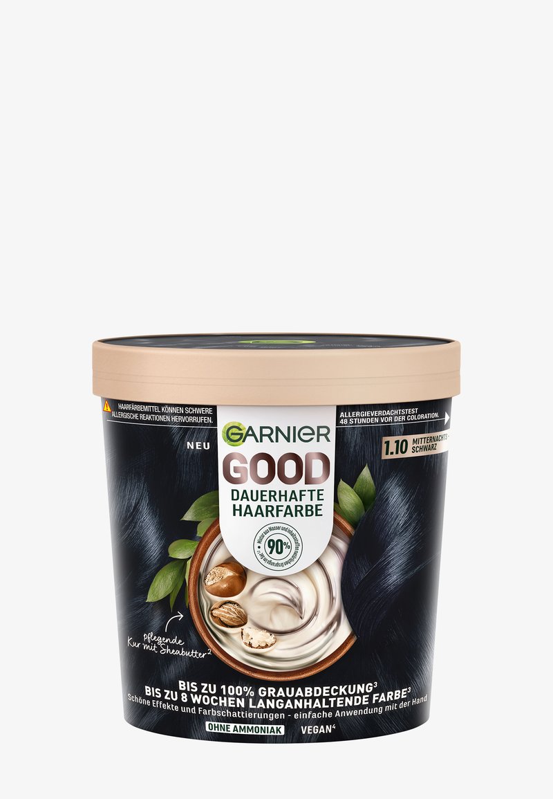 Garnier Bonne couleur permanente de cheveux dans un contenant en plastique noir et beige avec un couvercle circulaire, présentant une texture crémeuse et des accents de beurre de karité.
