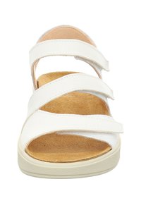Witte sandalen met drie verstelbare banden, een beige gevoerd voetbed en een lichte rubberen zool, met een eenvoudig, open-teen ontwerp.