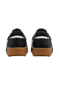 Scarpe da atletica nere con una parte superiore testurizzata, accenti bianchi e una suola in gomma naturale. Presentano un collare e un tallone imbottiti per supporto.