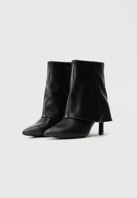 Black mid-calf leather boots with pointed toes and slim high heels, positioned side by side on a plain white background.