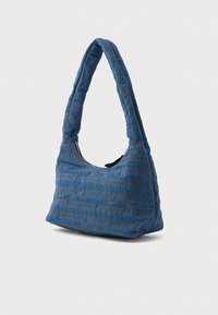 Bolsa de ombro azul acolchoada com uma alça curva, apresentando um padrão texturizado em azul mais escuro e bronze, com fecho com zip.