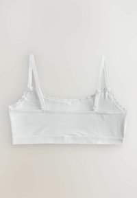 Bralette bianco con spalline regolabili, bordi a scallop e un morbido tessuto misto cotone. Caratterizzato da un design semplice e senza cuciture.