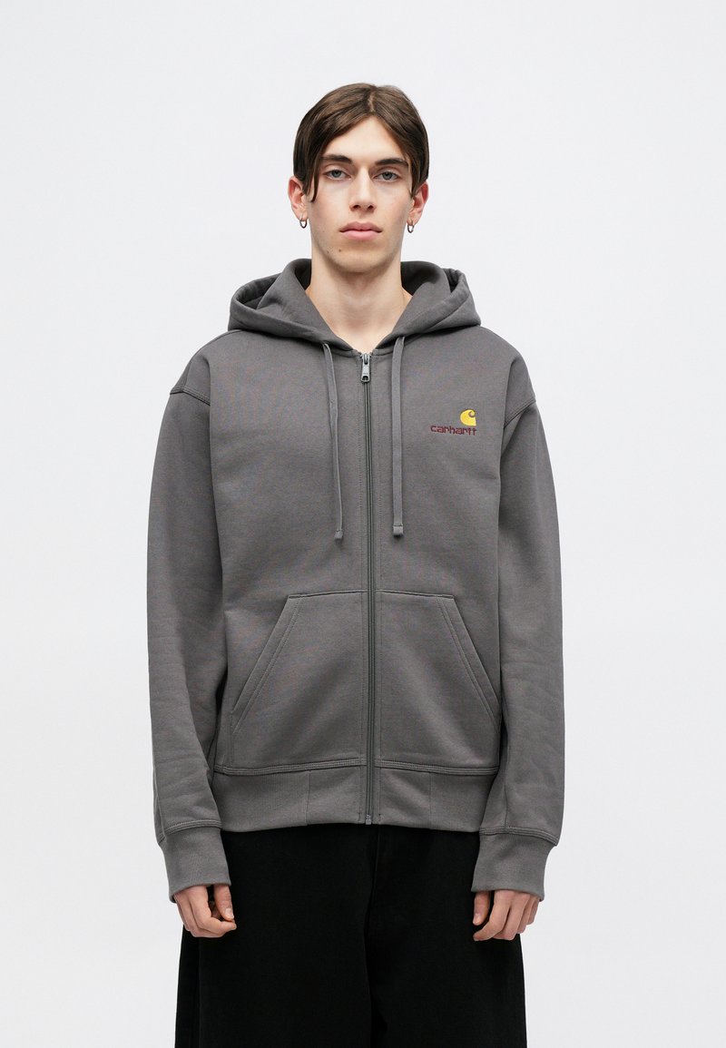 Grau-zipper Kapuzenpullover aus Baumwollmischung, mit zwei Fronttaschen, einer Kordelzugkapuze und einem kleinen gestickten Logo auf der Brust.