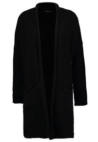 Long cardigan noir en maille avec ouverture frontale, deux poches à l'avant et un motif texturé sur les manches et le corps.