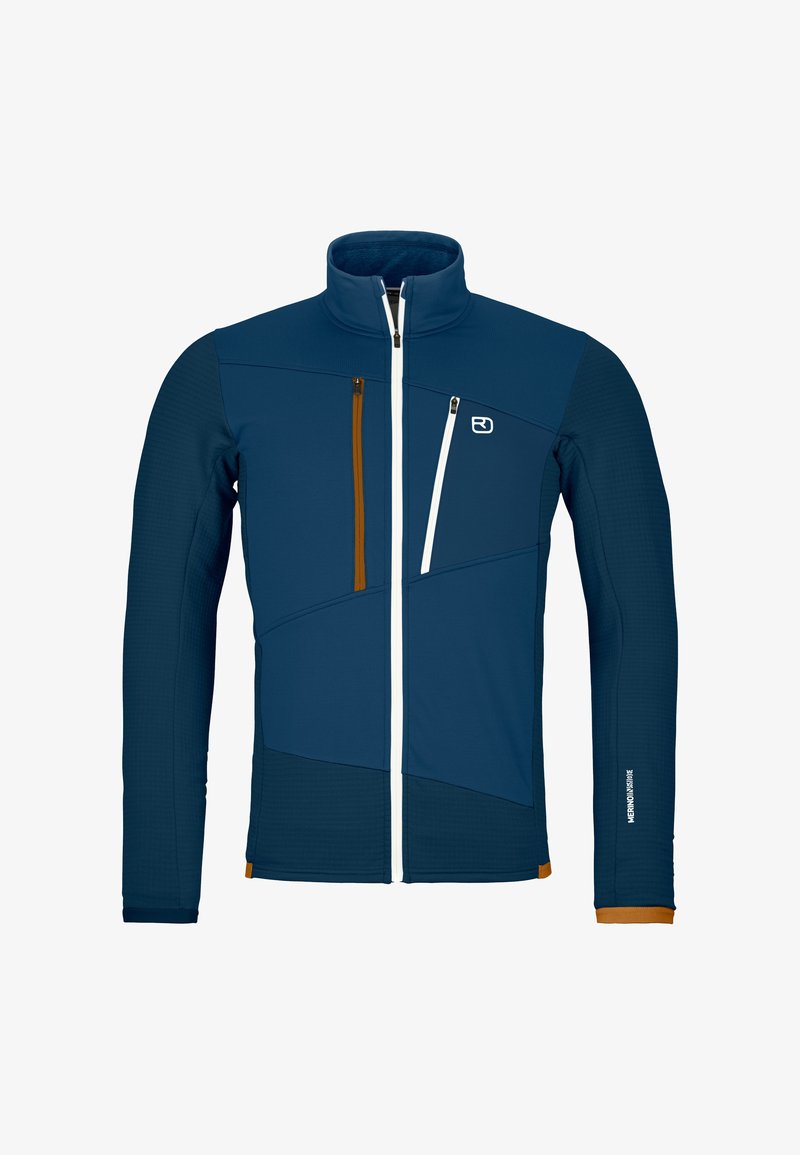 Men's zip-up jacket in dark blue with light blue and orange accents. Features a high collar, diagonal seam design, and two zippered pockets.