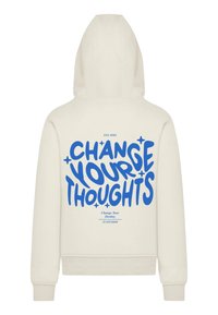 Cream hoodie with a kangaroo pocket and drawstring hood. Features blue text “CHANGE YOUR THOUGHTS” and smaller text below.
