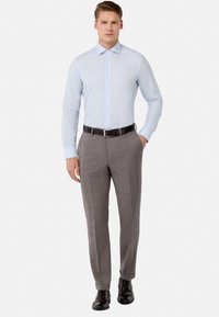 Light blue button-up shirt with a collar, gray plaid dress pants, black belt, and black dress shoes. Soft fabric with a tailored fit.