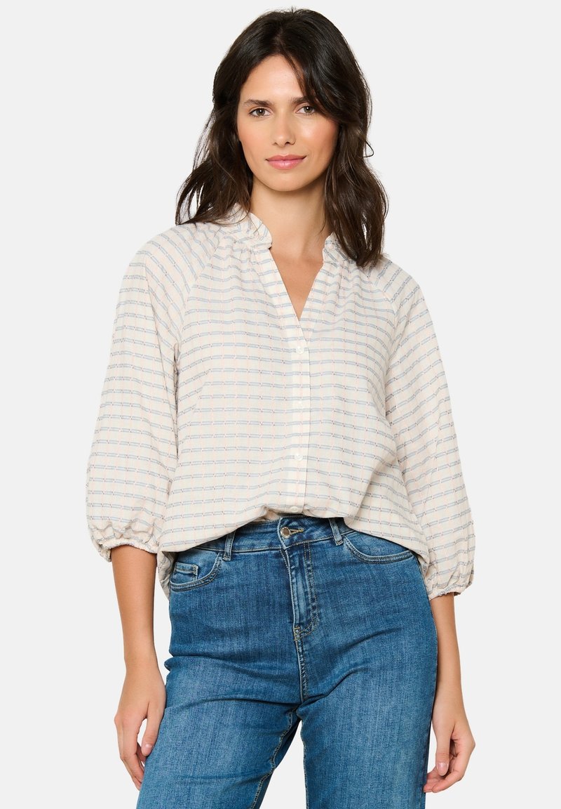 Lightweight, cream-colored blouse with a grid pattern in blue and red, collared neckline, and three-quarter sleeve with elastic cuffs.