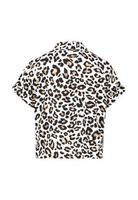 Cropped shirt in soft fabric featuring a white background with black and tan leopard spots. Short sleeves and a classic collar detail.