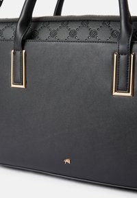 Black synthetic handbag with textured upper, gold hardware accents, and logo detail. Features sturdy handles and zipper closure.