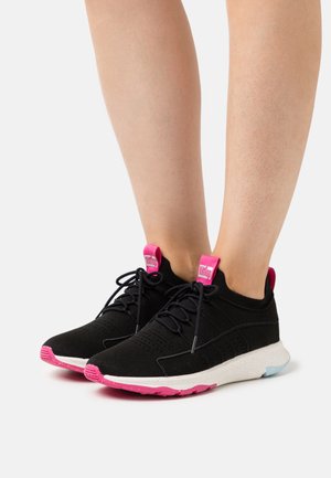 Zwarte sportieve schoenen met roze en blauwe accenten. Gebreid bovenwerk, gewatteerde witte tussenzool en veters voor een veilige pasvorm. Logo op de hielstuk.