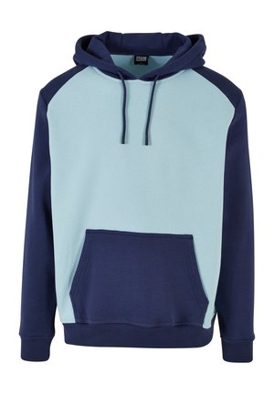 Kapucnis pulóver világoskék elejével és sötét tengerészkék ujjakkal. Kangaroo zsebe van, és állítható fűzővel rendelkezik. Puha pamut keverék anyag.