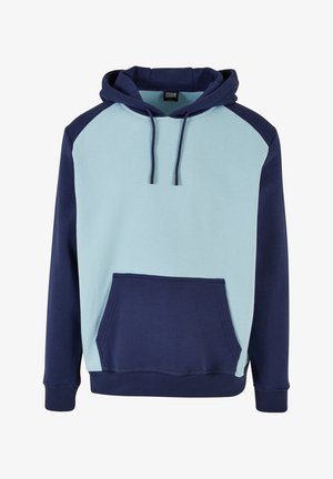 Kapucnis pulóver világoskék elejével és sötét tengerészkék ujjakkal. Kangaroo zsebe van, és állítható fűzővel rendelkezik. Puha pamut keverék anyag.