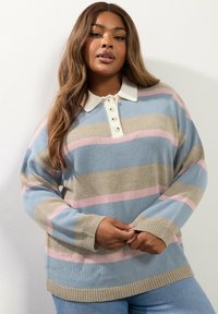 Maglione a righe con colori blu, beige e rosa, colletto bianco, bottoni e polsini a costine. Morbido tessuto a maglia.