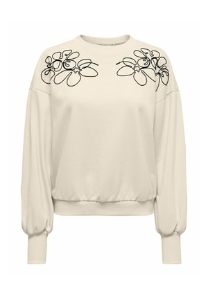 Cremefarbener Pullover mit Fledermausärmeln, verziert mit schwarzer Blumenstickerei auf den Schultern und einem gerippten Saum. Weiche Textur.