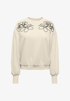Kremowa bluza z rękawami typu nietoperz, ozdobiona czarną kwiatową haftem na ramionach i ściągaczem u dołu. Miękka w dotyku.