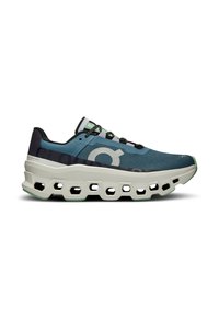Sport shoe with a blue and black mesh upper, featuring a chunky white midsole with cutouts and black laces. Green accents on the tongue.