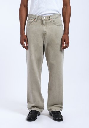 Light gray loose-fitting jeans with a straight leg, five-pocket design, and visible stitching details. Material shows a subtle texture.