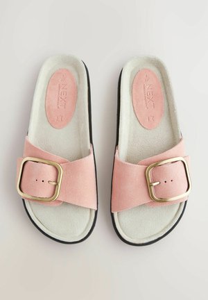 Roosa nahast sussid laia rihmaga, millel on kuldse tooni pandla, pehme sisemine vooder ja must välispõhi haardeks.