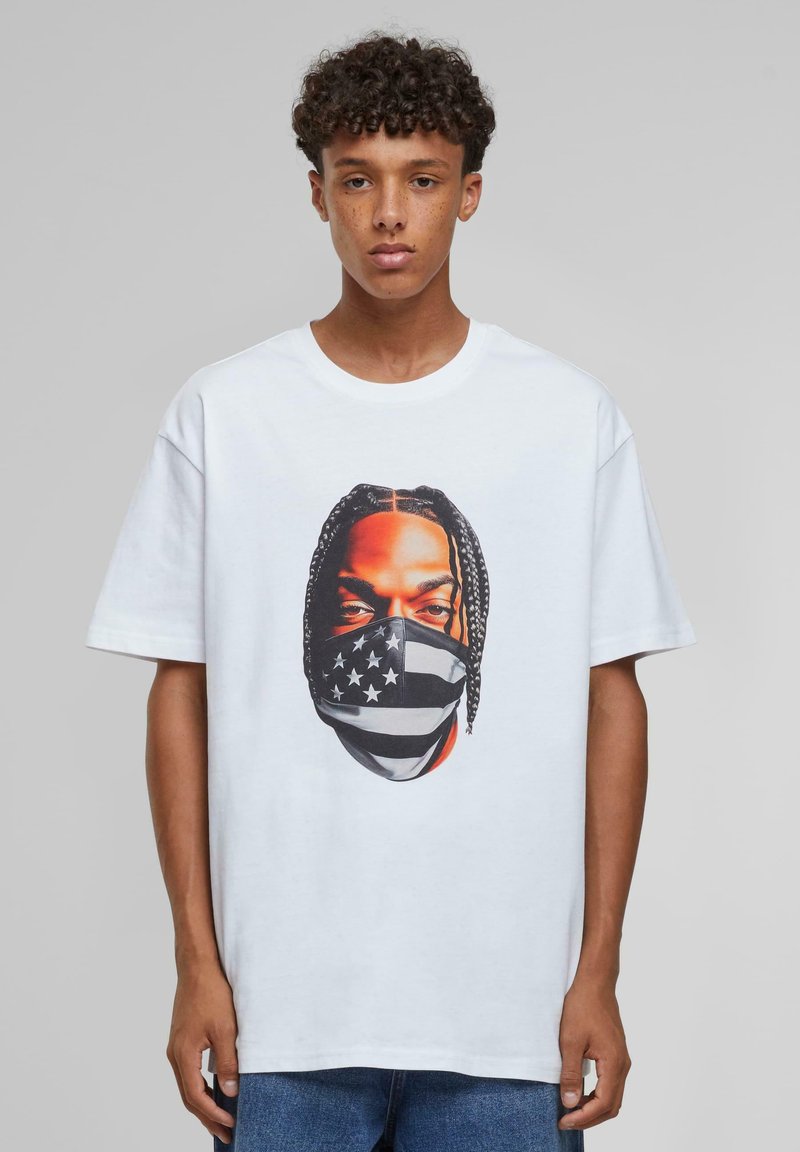White cotton T-shirt featuring a graphic print of a face in a mask with a black and white American flag design. Short sleeves and relaxed fit.