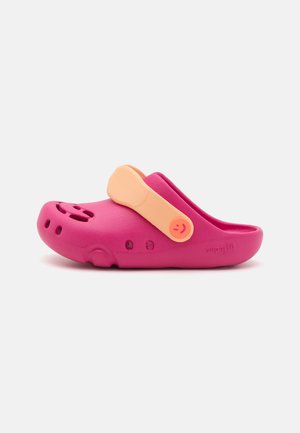 Pink clog made of lightweight material with a textured surface, featuring a contrasting orange adjustable strap and ventilation holes.