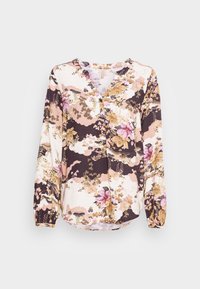Blusa floral com mangas longas, decote em V e detalhes franzidos. Apresenta uma mistura de padrões florais em roxo, rosa e creme sobre um fundo escuro.