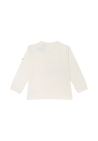 Top a maniche lunghe di colore crema realizzato in cotone morbido. Presenta un collo rotondo e una chiusura sul retro con tre bottoni. Senza motivi o dettagli visibili.