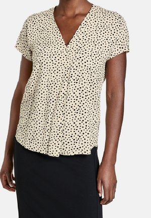 Korte mouwen blouse in beige met zwarte stippen, met een V-halsontwerp en zachte, lichte stof. Gladde textuur, iets losse pasvorm.