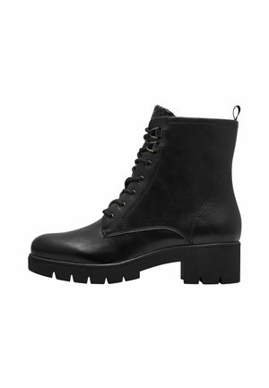 Bottine noire en cuir avec talon épais, semelle crantée, laçage à l'avant et languette à l'arrière.