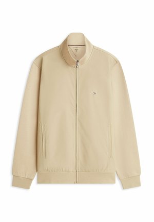 Giacca beige con cerniera, collo alto, maniche lunghe, due tasche laterali, polsini e orlo a coste, con piccolo logo Tommy Hilfiger sul petto.