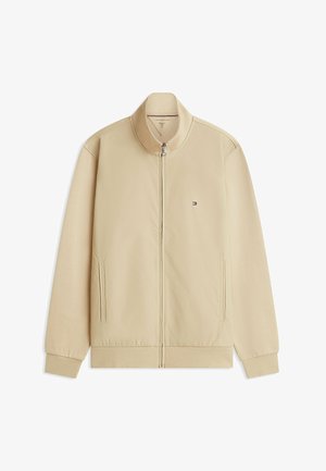 Giacca beige con cerniera, collo alto, maniche lunghe, due tasche laterali, polsini e orlo a coste, con piccolo logo Tommy Hilfiger sul petto.