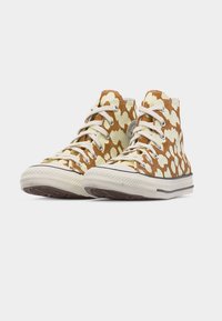 Πάνινα αθλητικά παπούτσια υψηλού λαιμού με καφέ και κρεμ αφηρημένες κηλίδες, λευκά κορδόνια και λευκές καουτσούκ σόλες, στραμμένα προς τα εμπρός σε λευκό φόντο.