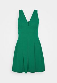 Grön ärmlös klänning med V-ringning, plisserad kjol, tillverkad av ett glatt tyg, med en dragkedja bak.