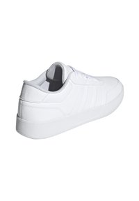 White athletic shoe with smooth synthetic leather upper, lace closure, textured outsole, and three embossed stripes on the side.