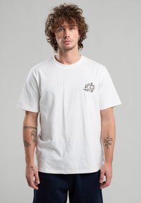 White cotton t-shirt with a round neck and short sleeves. Features a black graphic design on the left chest. Smooth texture.