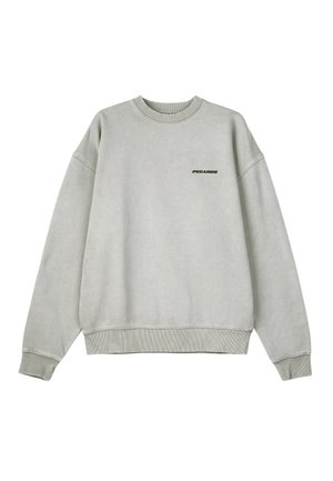 Light grey sweatshirt with ribbed cuffs and hem. Features a small black "PEGADOR" logo on the front. Soft texture, oversized fit.