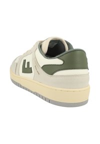White and olive green sneaker featuring a suede and leather upper, round toe, and a cushioned sole with textured accents and branding.